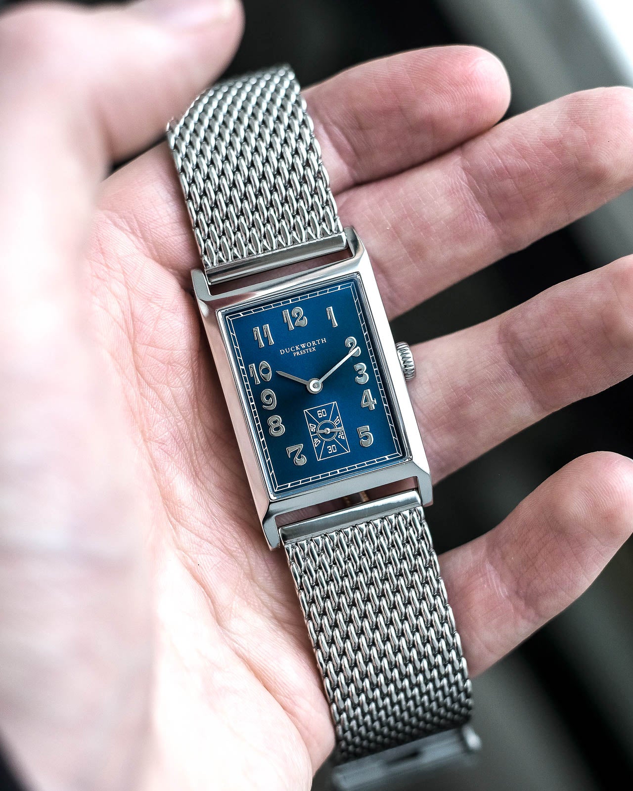 
                  
                    Centenary blue dial on steel mesh bracelet
                  
                